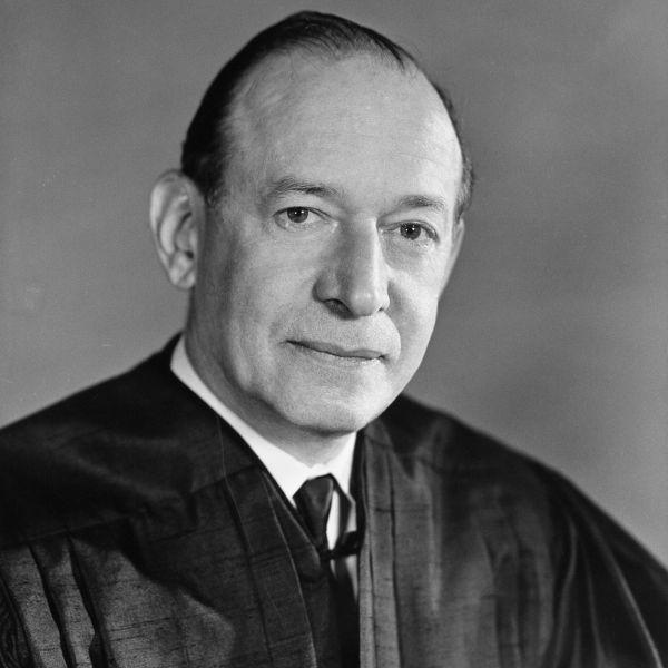 A black and white photo of a man in judges robes.