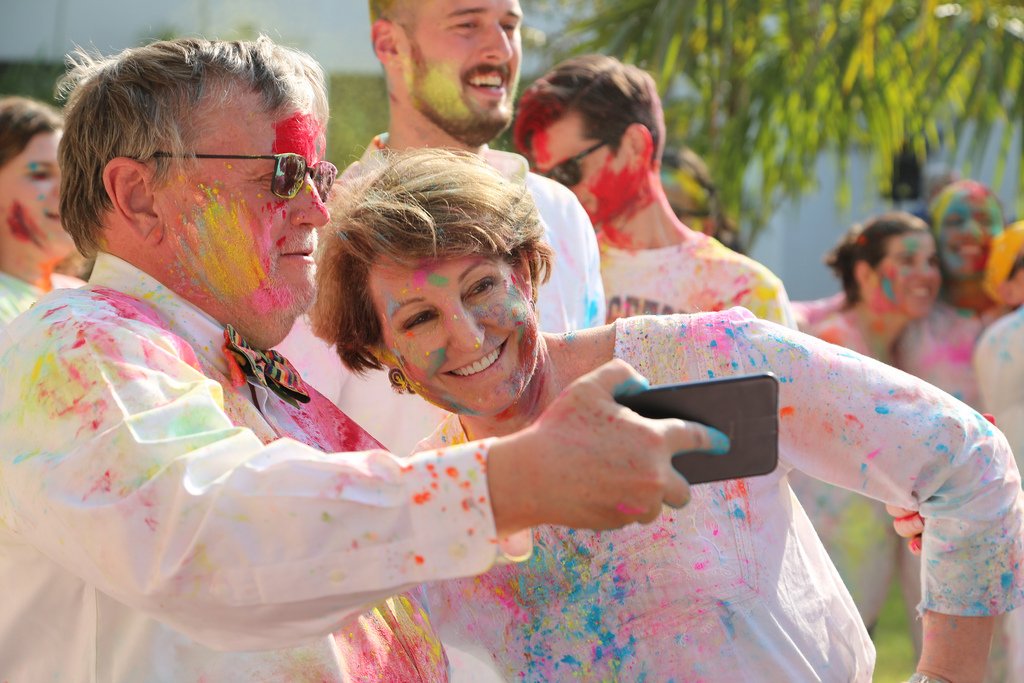 MaryKay Carlson covered in colorful powder at a Holi celebration