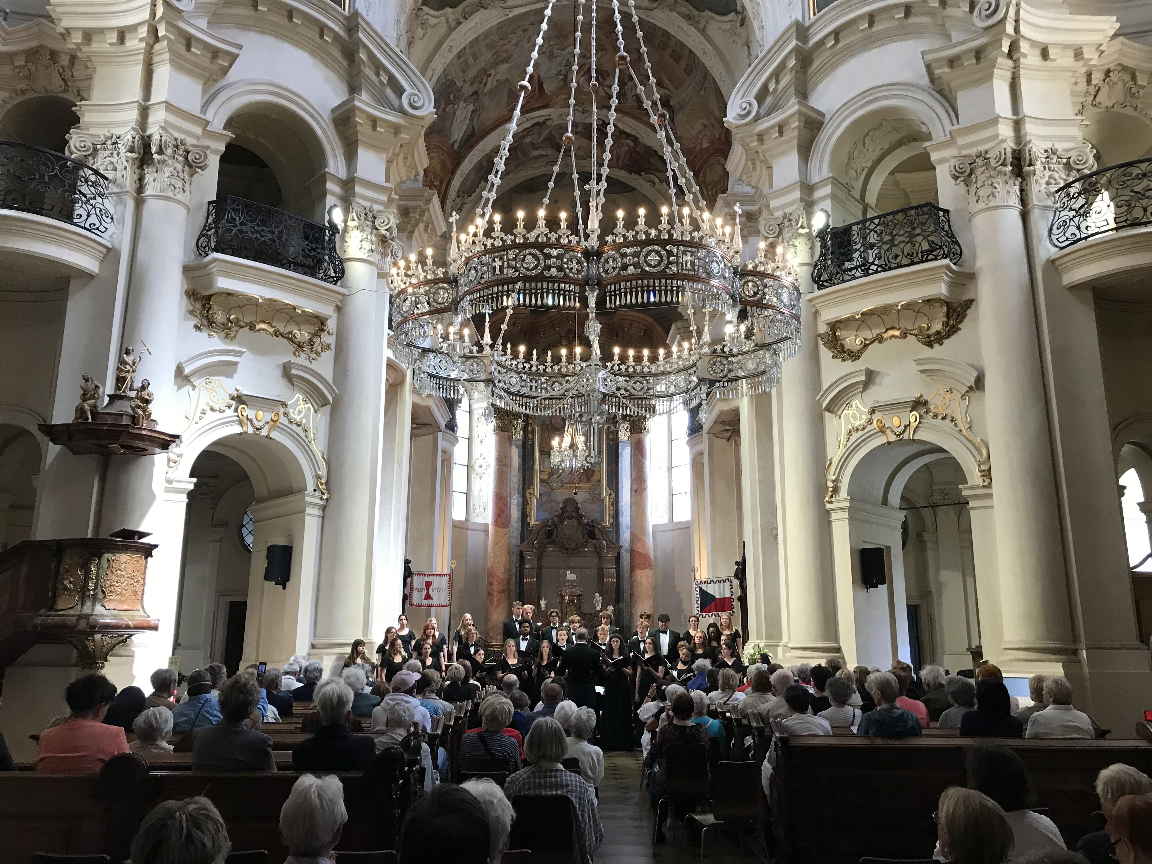 a large choir sings in a cathedral