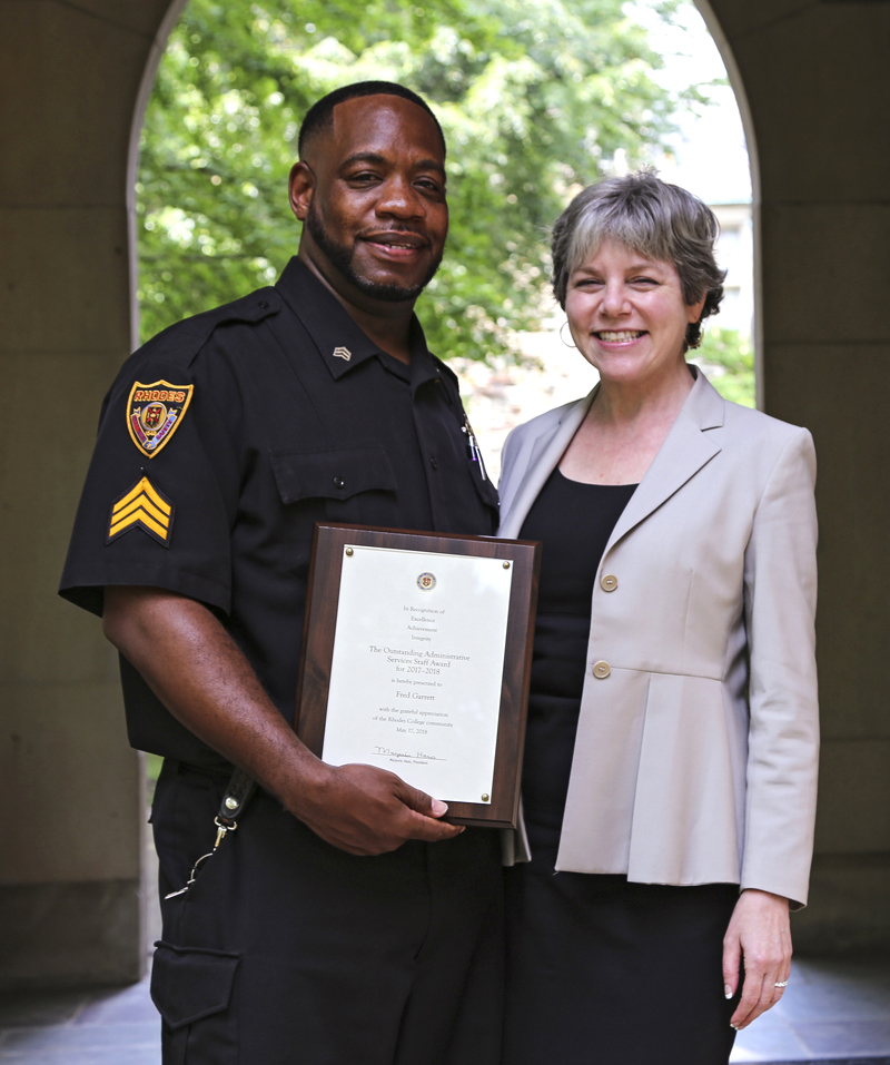 Award winner stands with college president holding award