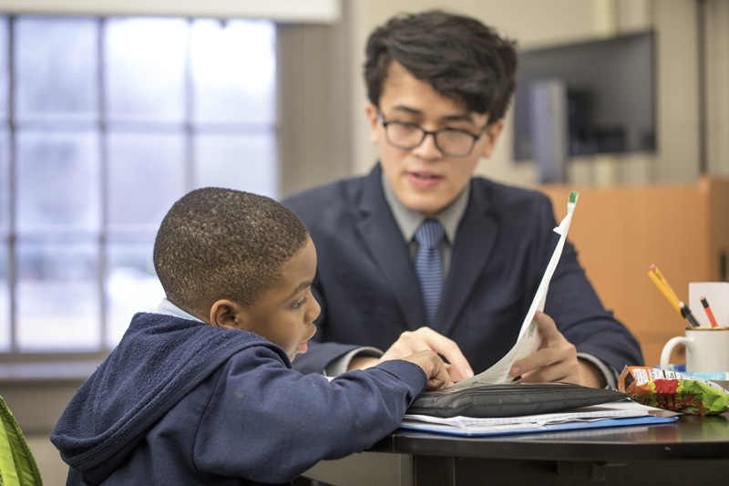 a student teaching a child