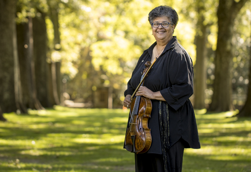 African American woman holding a viola