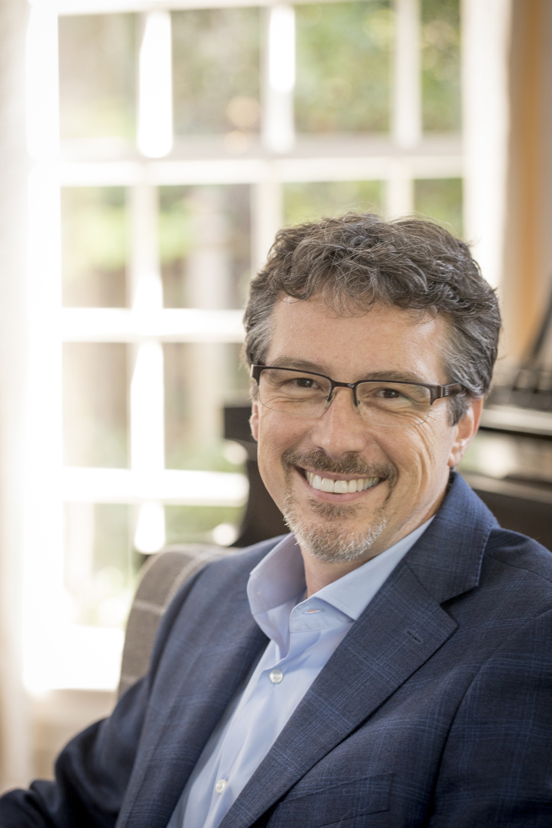 head shot of Dr. Larry Hass, a middle-aged man wearing glasses