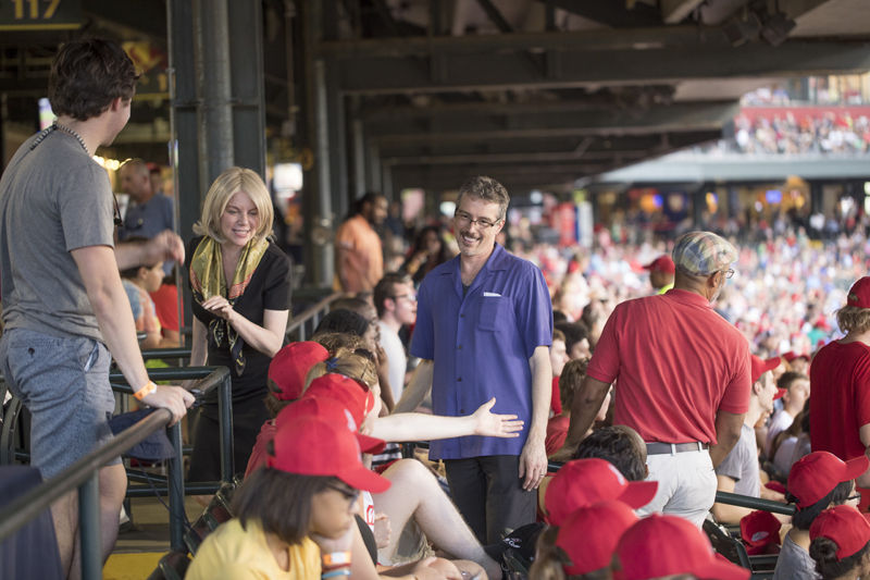 President Hass and Dr. Larry Hass visit with students as a baseball game