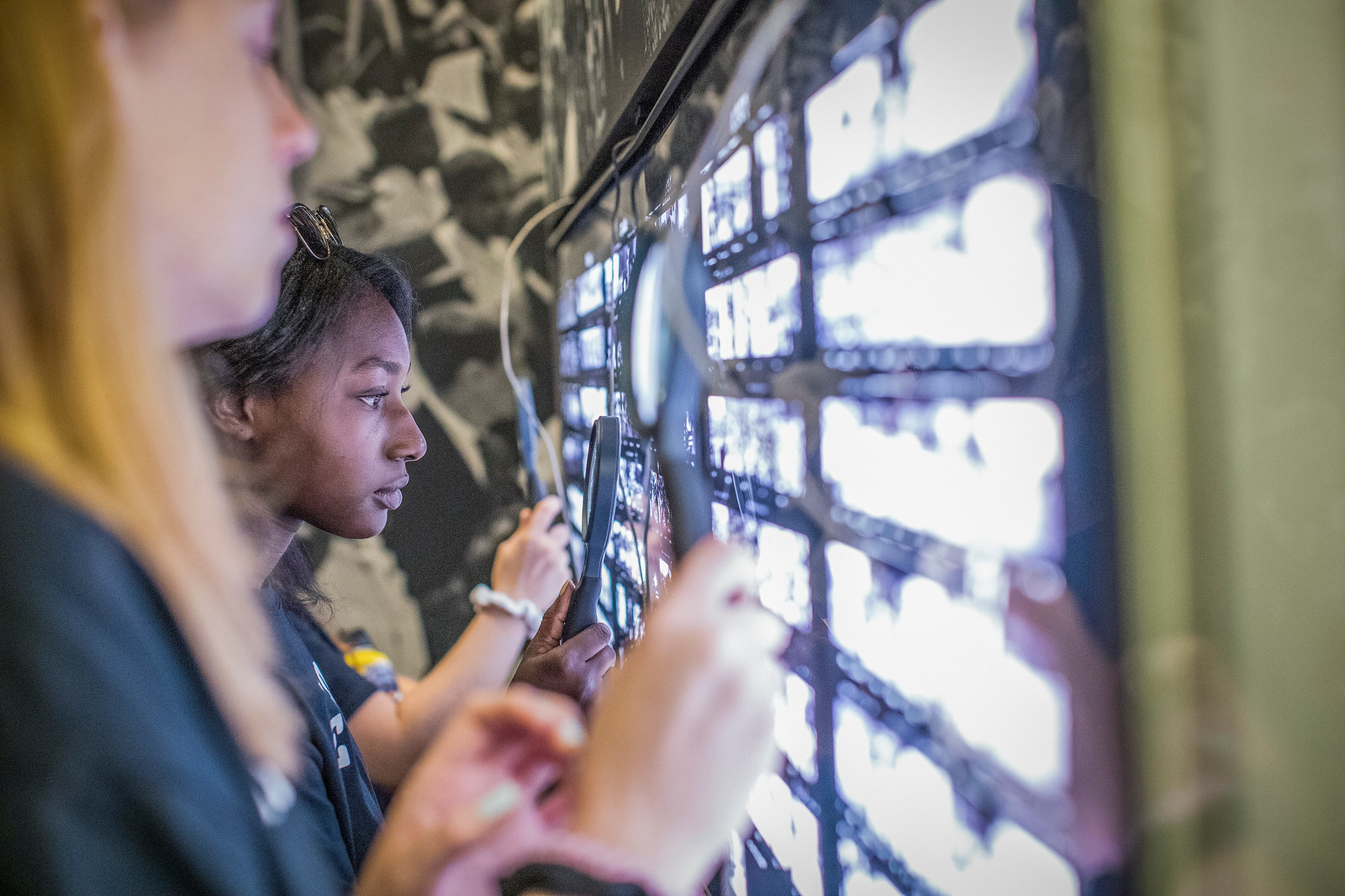 Students use magnifying glasses 