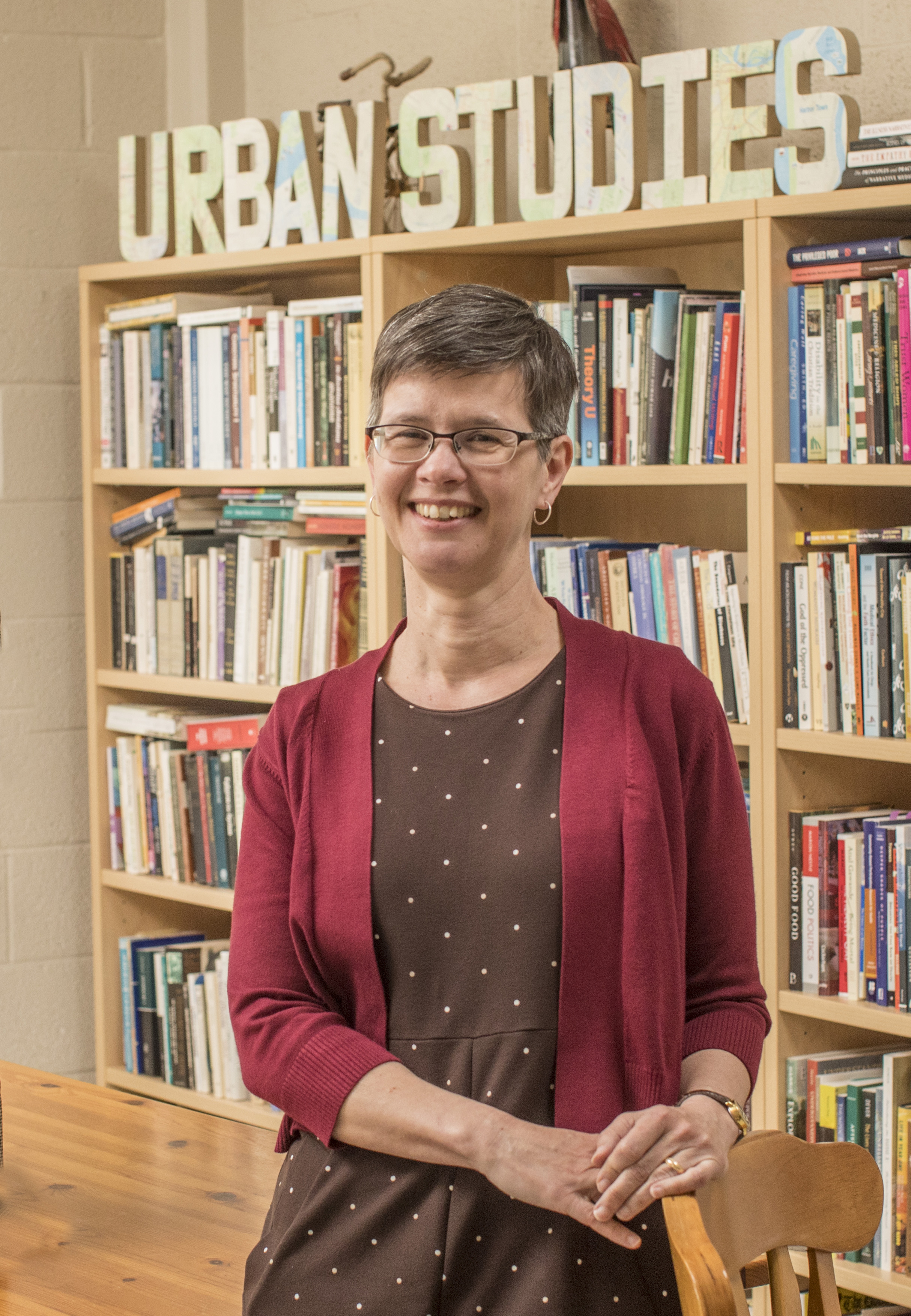 Woman standing in front of bookcase