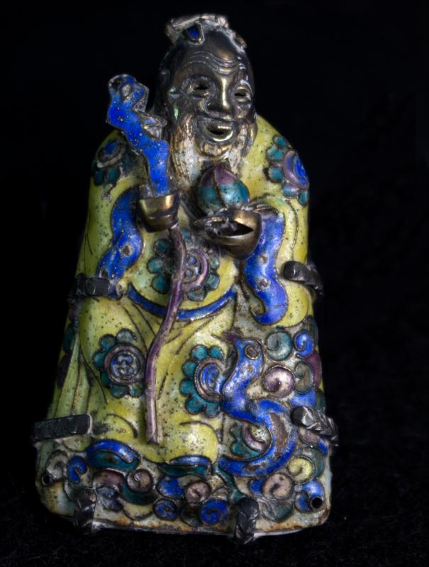 a small blue and green figurine of a woman