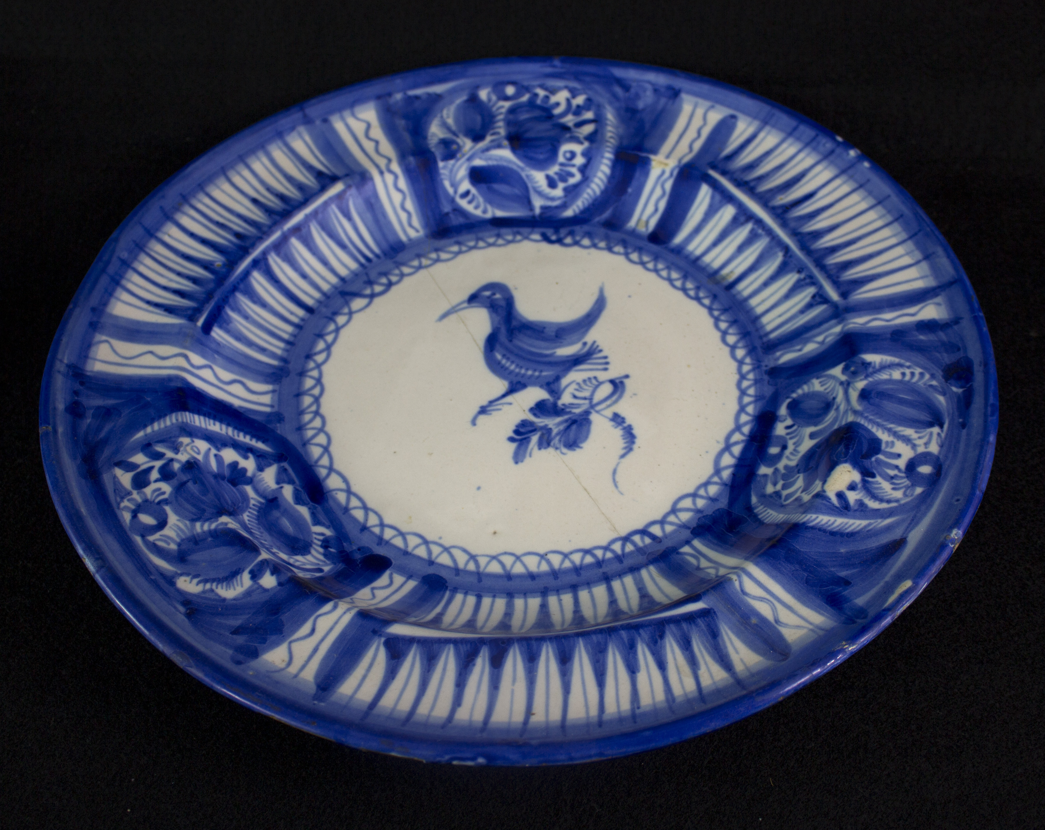 a blue and white plate with the image of a duck