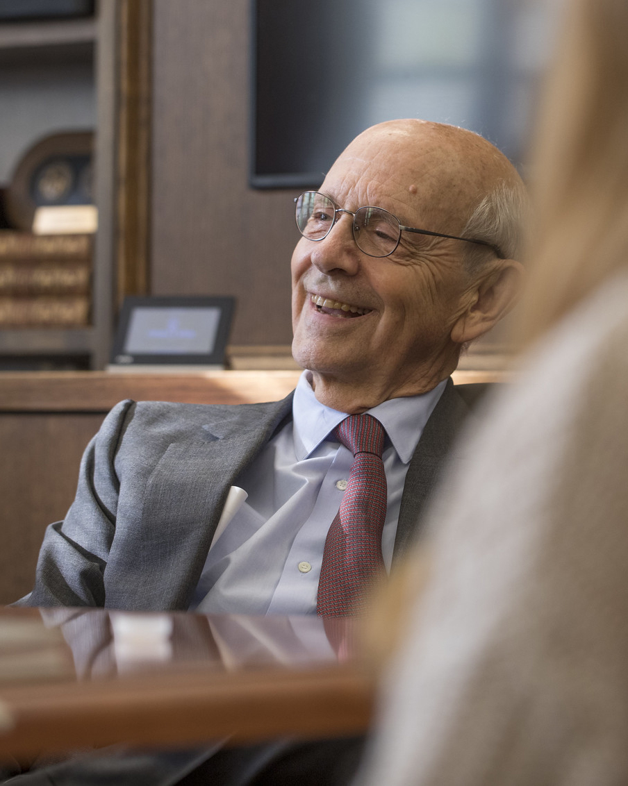 an older man smiles at students