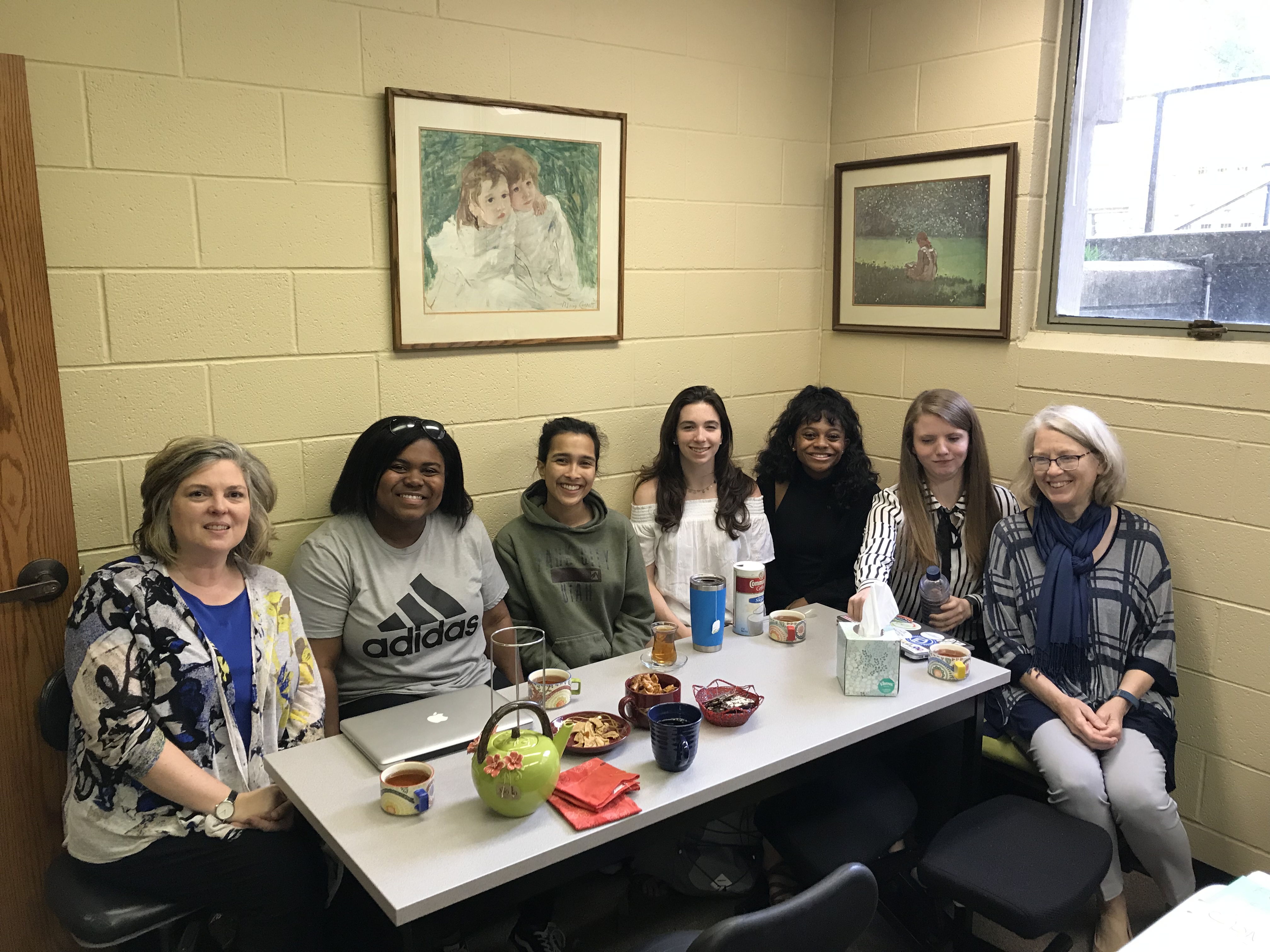 Seven people sit around a table