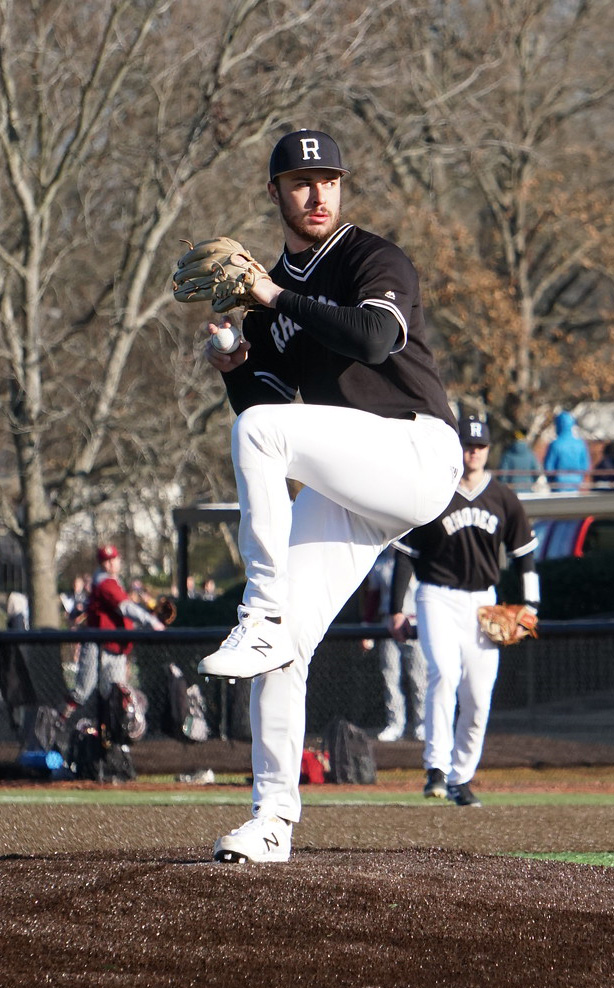 a baseball pitcher begins his windup on the mound