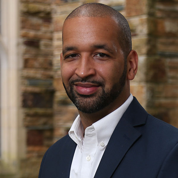 an African American man in a blue jacket