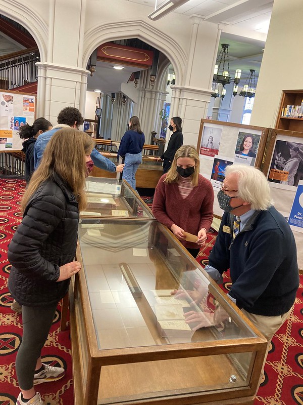 a group of people work on a display case