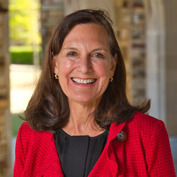 a woman with shoulder-length hair in a red suit