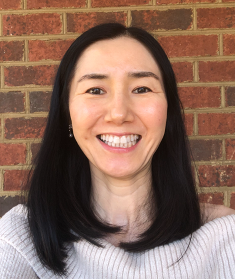 a young Japanese woman smiles at the camera