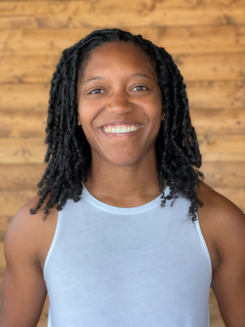 a young African American woman smiles at the camera