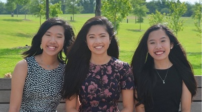image of Ellen Ouyang sitting with her two sister