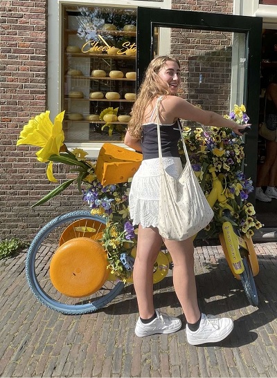 image of student Sophia Nappi standing in front of a bike