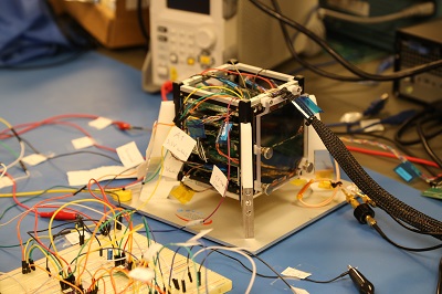 image of Rhodes College created four-inch cube satellite in progress