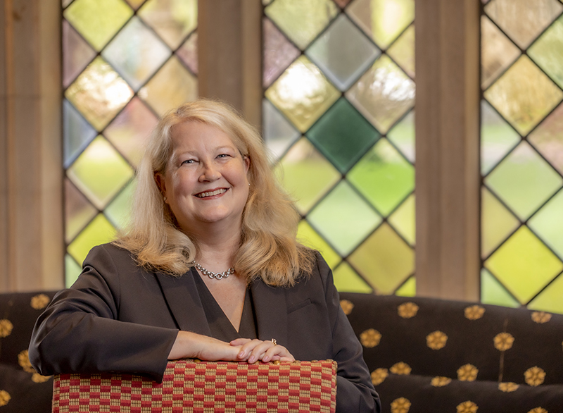  Jennifer Collins seated in front of a stained glass window