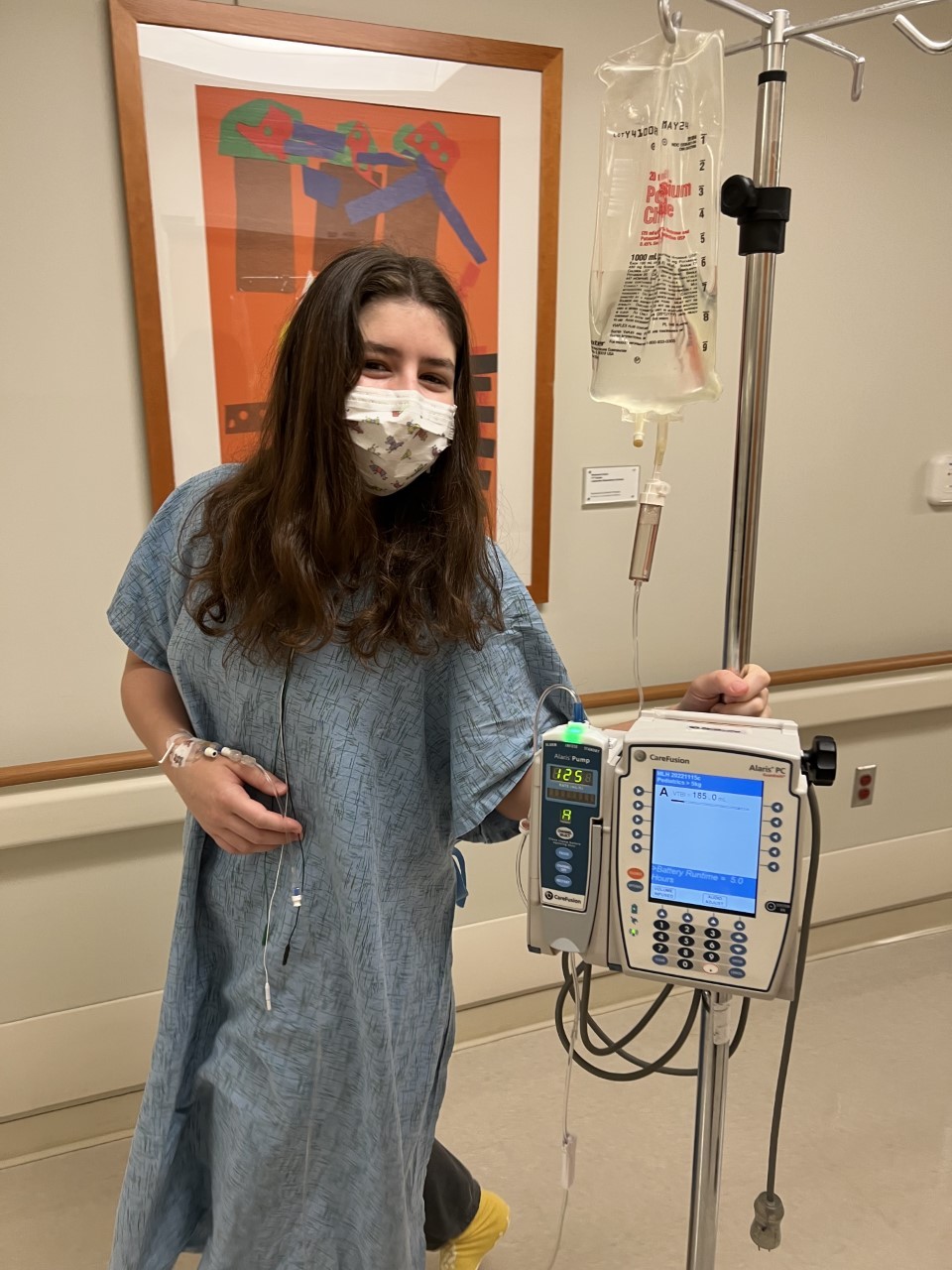 a young woman in medical garb with an I.V.