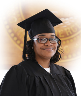 a middle-aged African American woman in graduation regalia