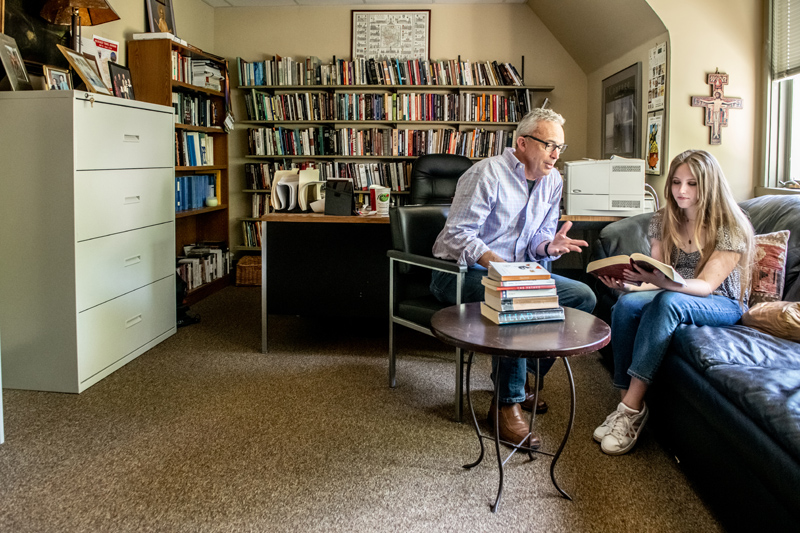 a professor and student confer in his office