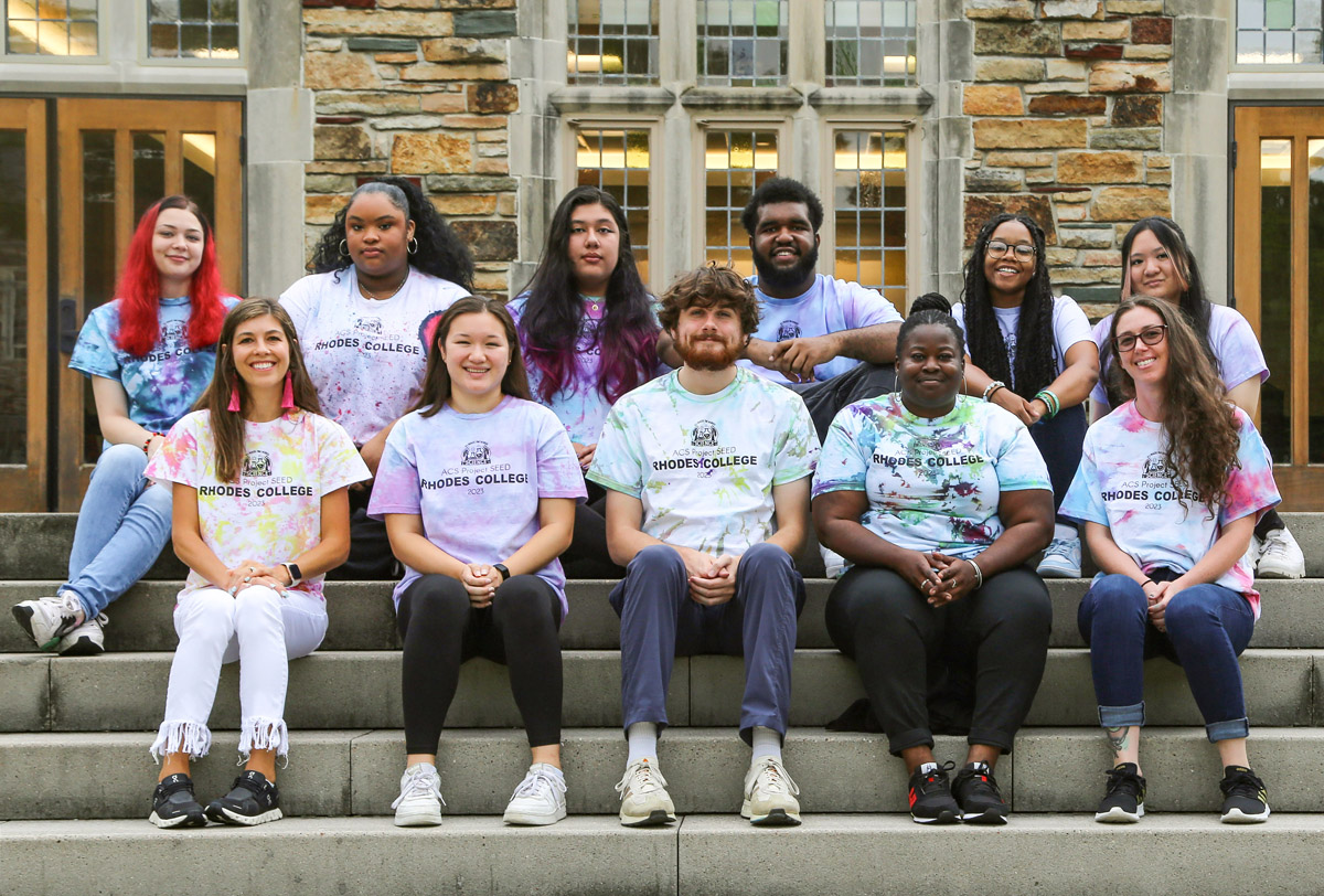  a group of students and teachers sit on the steps