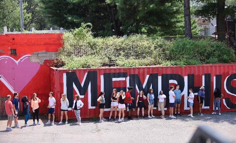 image of Rhodes College students in front of Memphis sign