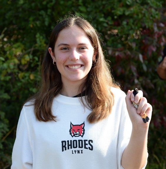 image of student A. Baroody holding unharmed bird as part of research of migratory birds
