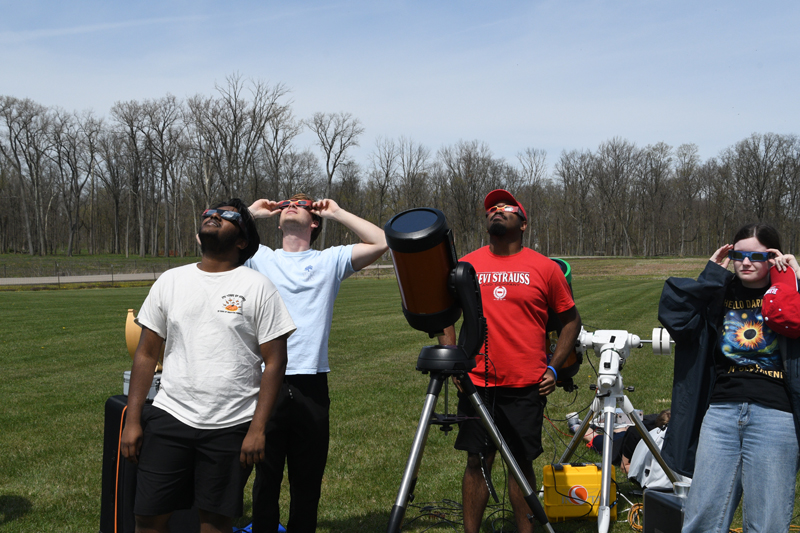 students observing the eclipse on a field trip