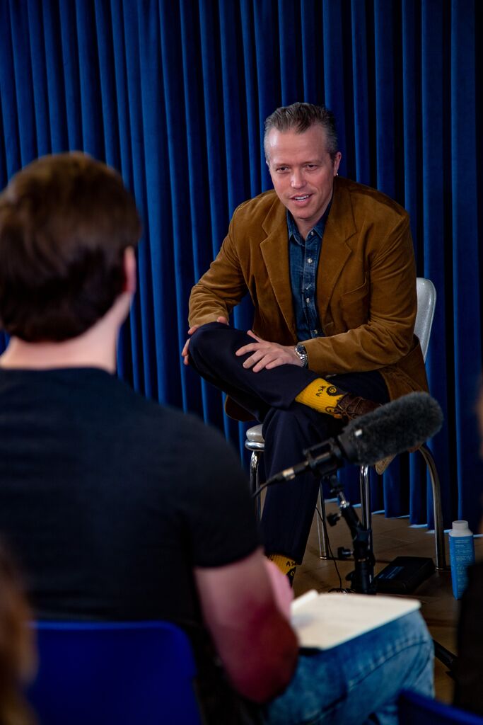 a man speaks with a student in class