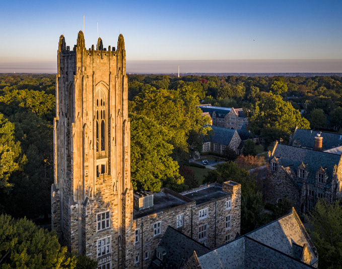 a Gothic bell tower over a campus