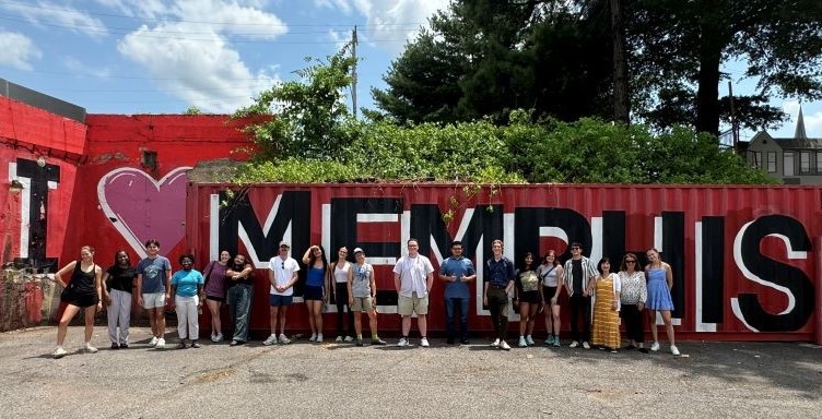 image of Rhodes College students standing in front of I Love Memphis sign