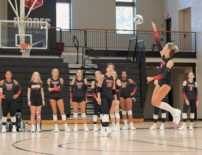 a young woman returns a volleyball on the court