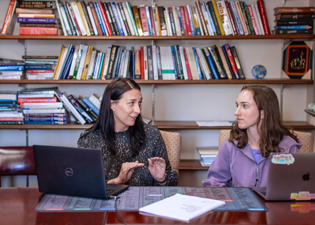 a professor and a student consult in the professor's office