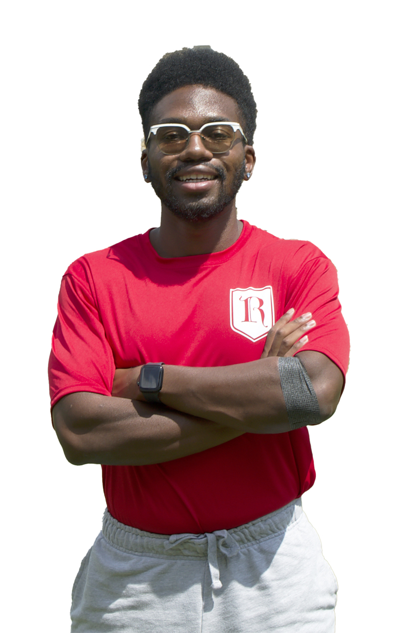 a young African American man smiles at the camera