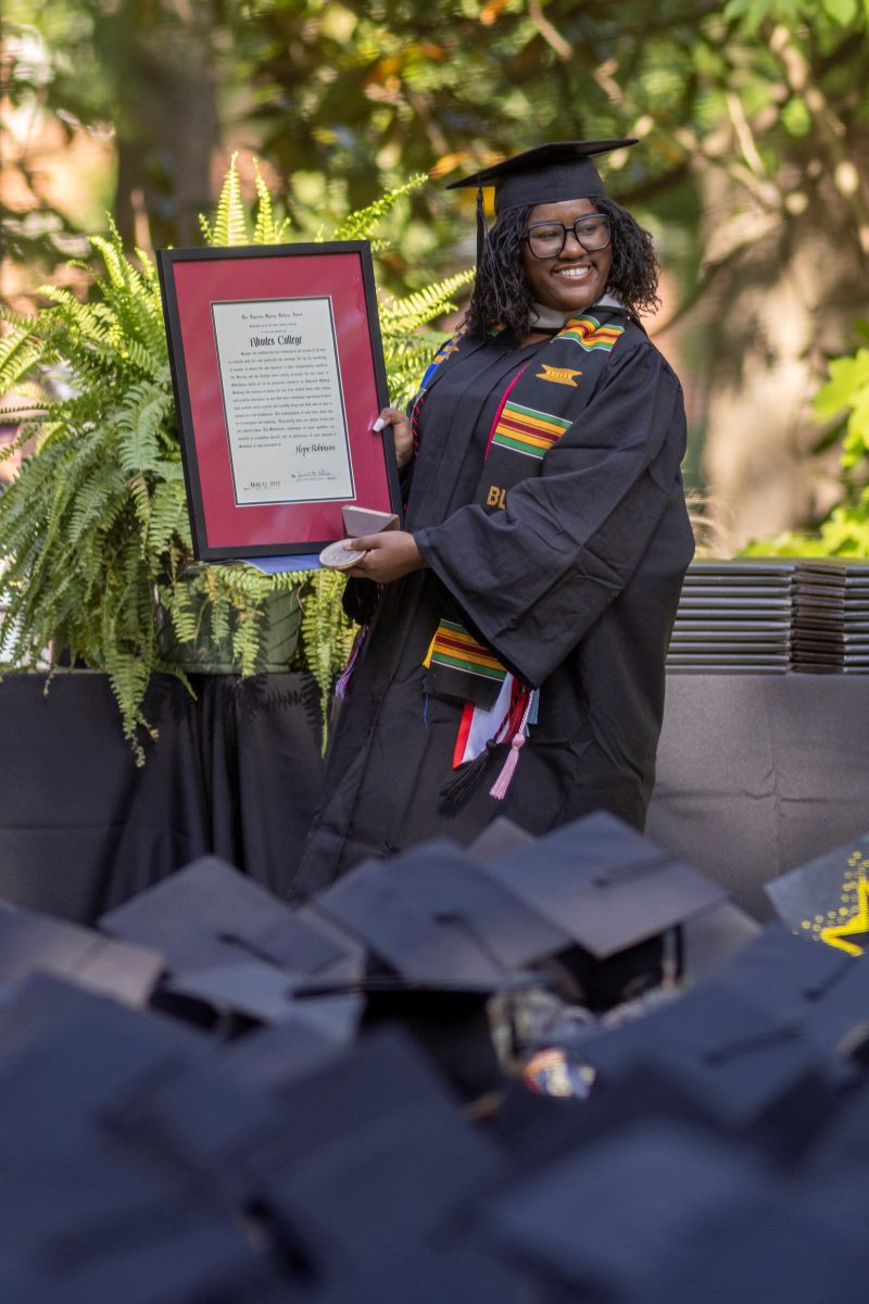 image of Hope Robinson holding a plaque