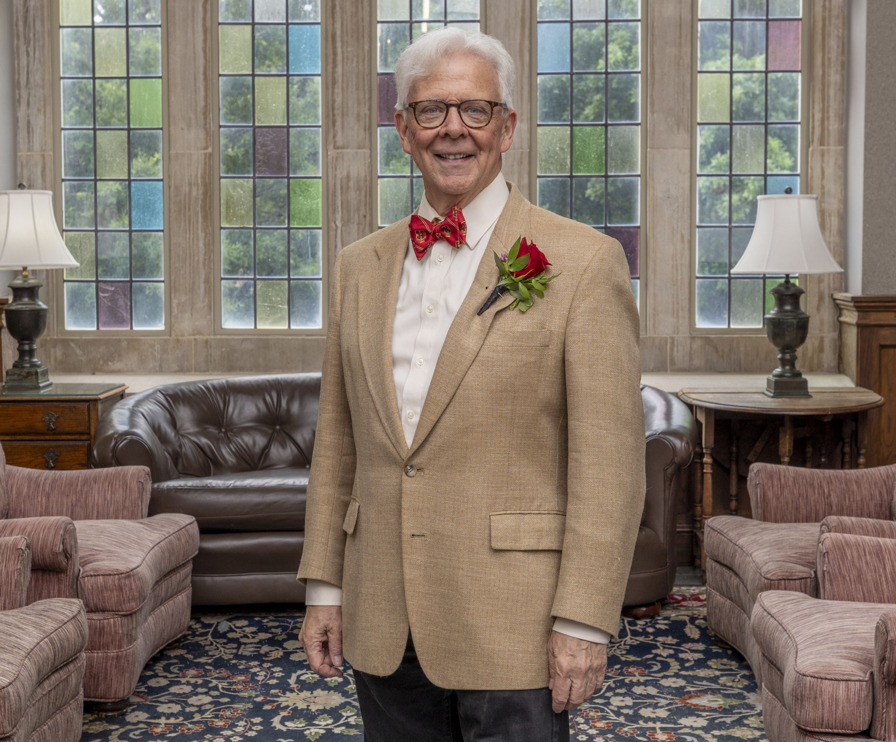 image of Bill Short standing in front of stained glass windows