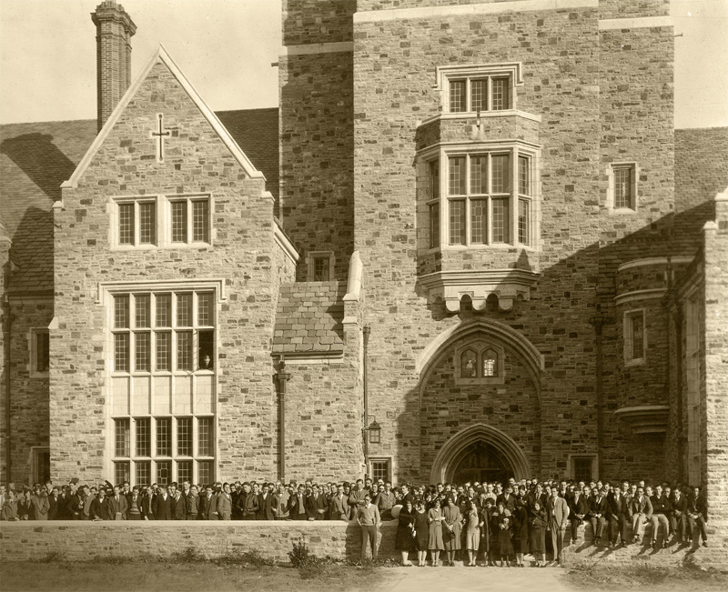 a large group of students lined up in front of a Gothic building