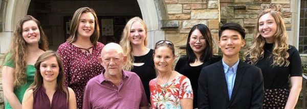 group image of Rhodes students and Robert Buckman in front of Buckman Hall on the Rhodes campus