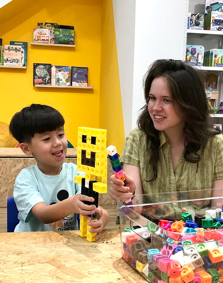a young woman play with a young boy
