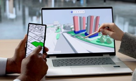 hands pointing to mapping tools on a phone and laptop