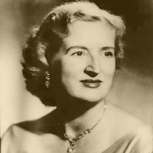 A sepia toned photo of a woman with curly hair looking out the right of frame.