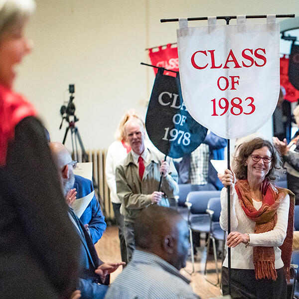 alumni carrying class banners