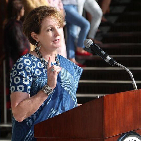 MaryKay Carlson speaking at an podium