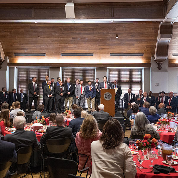 a large banquet hall with people on stage