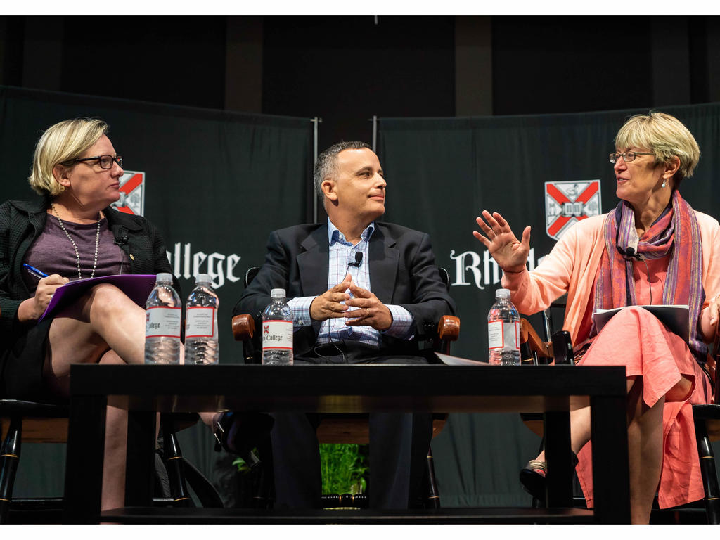 three panelists on a stage