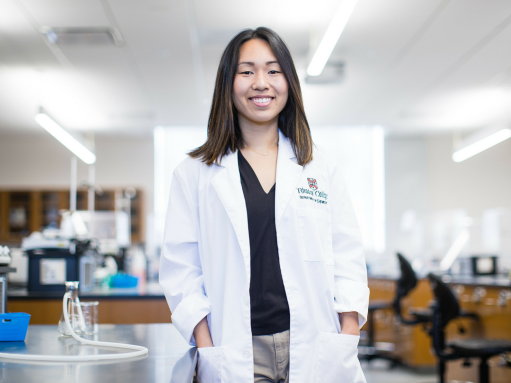 female student in lab coat in laboratory