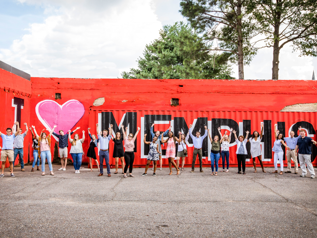 Rhodes students in front of I love Memphis sign 